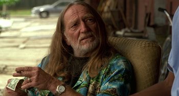 Movie still from “Half Baked” (1998), directed by Tamra Davis – An older man with long hair and a beard; Close Up shot, Over the shoulder angle
