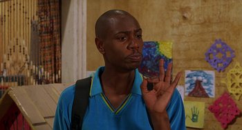 Movie still from “Half Baked” (1998), directed by Tamra Davis – A man making an okay sign with his hand; Close Up shot, Low angle