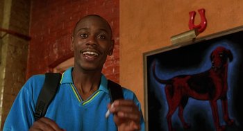 Movie still from “Half Baked” (1998), directed by Tamra Davis – A young man is smiling while holding a cigarette; Close Up shot, Low angle