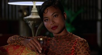 Movie still from “Half Baked” (1998), directed by Tamra Davis – A woman holding a wine glass in her right hand; Close Up shot, Over the shoulder angle