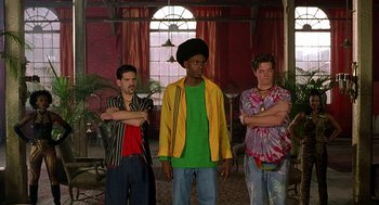 Movie still from “Half Baked” (1998), directed by Tamra Davis – A group of men standing next to each other in front of a window; Medium shot, Low angle