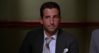 Movie still from “Half Baked” (1998), directed by Tamra Davis – A person wearing a suit and tie; Close Up shot, Low angle