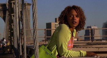 Movie still from “Half Baked” (1998), directed by Tamra Davis – A woman in a yellow shirt and a yellow purse; Medium shot, Low angle