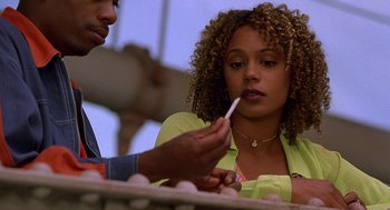 Movie still from “Half Baked” (1998), directed by Tamra Davis – A man and a woman sitting at a table with food in front of them; Close Up shot, Over the shoulder angle