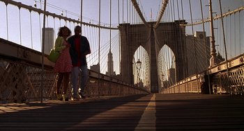 Movie still from “Half Baked” (1998), directed by Tamra Davis – A man and a woman standing on a bridge; Wide shot, Low angle