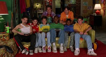 Movie still from “Half Baked” (1998), directed by Tamra Davis – A group of young men sitting on top of a yellow couch; Medium shot, Low angle