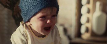 Movie still from “Halloween” (2007), directed by Rob Zombie – A little boy wearing a blue knitted hat and crying; Close Up shot, High angle