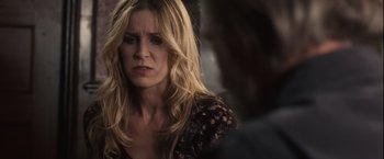 Movie still from “Halloween” (2007), directed by Rob Zombie – A woman with long blonde hair is looking sad; Close Up shot, Over the shoulder angle