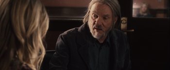 Movie still from “Halloween” (2007), directed by Rob Zombie – An older man with long hair and a beard; Close Up shot, Over the shoulder angle