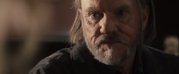 Movie still from “Halloween” (2007), directed by Rob Zombie – An old man with long hair and a beard; Close Up shot, Low angle