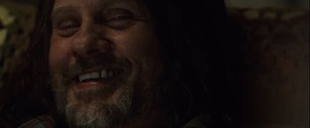 Movie still from “Halloween” (2007), directed by Rob Zombie – A person with long hair and a beard; Extreme Close Up shot, Low angle