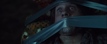 Movie still from “Halloween” (2007), directed by Rob Zombie – A man with a duct tape over his mouth; Close Up shot, Low angle