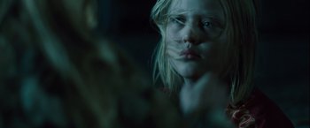 Movie still from “Halloween” (2007), directed by Rob Zombie – A young blonde haired woman with a cat's face; Close Up shot, Over the shoulder angle