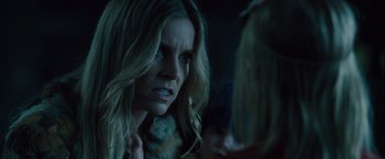 Movie still from “Halloween” (2007), directed by Rob Zombie – A person with long blonde hair; Close Up shot, Over the shoulder angle