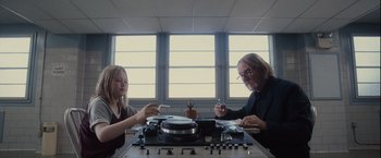 Movie still from “Halloween” (2007), directed by Rob Zombie – A man and a woman sitting in front of a stove; Medium shot, Low angle