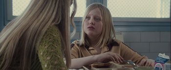 Movie still from “Halloween” (2007), directed by Rob Zombie – A young girl sitting in front of another young girl; Close Up shot, Over the shoulder angle