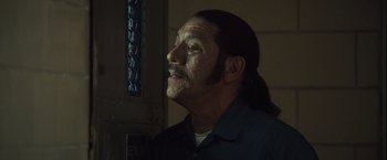 Movie still from “Halloween” (2007), directed by Rob Zombie – A man with long black hair and a mustache; Close Up shot, Over the shoulder angle