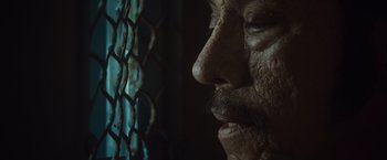 Movie still from “Halloween” (2007), directed by Rob Zombie – An old man with a beard is looking through a chain link fence; Extreme Close Up shot, Low angle