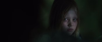 Movie still from “Halloween” (2007), directed by Rob Zombie – A young girl with red eyes stares into the camera; Close Up shot, Low angle