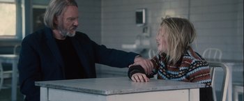 Movie still from “Halloween” (2007), directed by Rob Zombie – A man and a girl are shaking hands; Medium shot, Over the shoulder angle