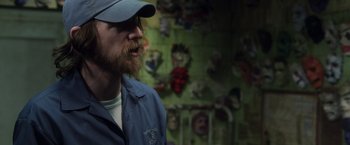 Movie still from “Halloween” (2007), directed by Rob Zombie – A man with a beard wearing a blue jacket; Close Up shot, Over the shoulder angle