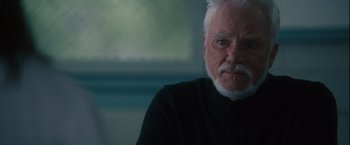 Movie still from “Halloween” (2007), directed by Rob Zombie – An older man with white hair and a mustache; Close Up shot, Over the shoulder angle