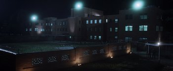 Movie still from “Halloween” (2007), directed by Rob Zombie – A building that is lit up at night time; Extreme Wide shot, Low angle