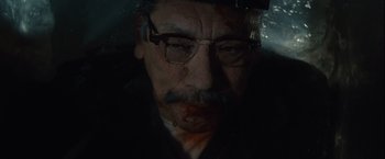 Movie still from “Halloween” (2007), directed by Rob Zombie – An old man with a beard and mustache wearing glasses; Close Up shot, High angle