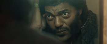 Movie still from “Halloween” (2007), directed by Rob Zombie – A person with a beard looking at the camera; Close Up shot, High angle