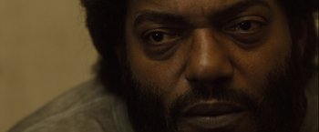 Movie still from “Halloween” (2007), directed by Rob Zombie – A man with a beard and mustache; Extreme Close Up shot, High angle