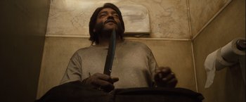 Movie still from “Halloween” (2007), directed by Rob Zombie – A man holding a knife in his hands; Close Up shot, Low angle