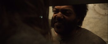 Movie still from “Halloween” (2007), directed by Rob Zombie – A person with a beard; Close Up shot, Over the shoulder angle