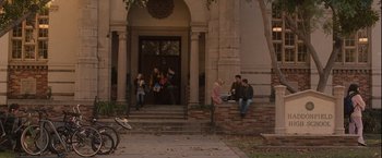 Movie still from “Halloween” (2007), directed by Rob Zombie – A group of people sitting on the steps of a building; Extreme Wide shot, High angle