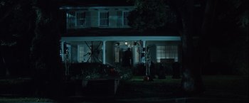 Movie still from “Halloween” (2007), directed by Rob Zombie – A man standing in front of a house; Extreme Wide shot, High angle
