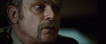 Movie still from “Halloween” (2007), directed by Rob Zombie – A man with a mustache; Close Up shot, Low angle