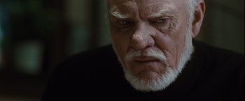 Movie still from “Halloween” (2007), directed by Rob Zombie – An old man with a white beard looking angry; Close Up shot, Low angle