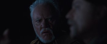 Movie still from “Halloween” (2007), directed by Rob Zombie – An old man with a white beard stares at the camera; Close Up shot, Over the shoulder angle
