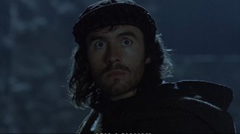 Movie still from “Hamlet” (1990), directed by Franco Zeffirelli – A person with long hair wearing a hat; Close Up shot, Low angle