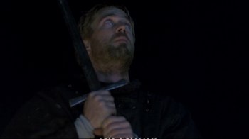Movie still from “Hamlet” (1990), directed by Franco Zeffirelli – A man holding a sword up to his face; Medium shot, Low angle
