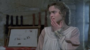 Movie still from “Hamlet” (1990), directed by Franco Zeffirelli – A young woman in a white dress holding her hand up to her face; Close Up shot, Over the shoulder angle