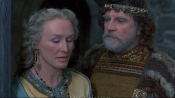 Movie still from “Hamlet” (1990), directed by Franco Zeffirelli – A woman and a man in medieval garb looking at each other; Close Up shot, Over the shoulder angle