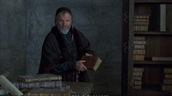 Movie still from “Hamlet” (1990), directed by Franco Zeffirelli – An older man holding a book in his hands; Medium shot, Low angle