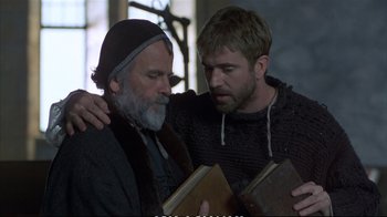 Movie still from “Hamlet” (1990), directed by Franco Zeffirelli – Two men are holding a book and looking at each other; Medium shot, Over the shoulder angle