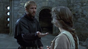 Movie still from “Hamlet” (1990), directed by Franco Zeffirelli – A man and a woman in medieval garb talking to each other; Medium shot, Over the shoulder angle