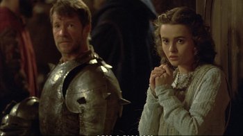 Movie still from “Hamlet” (1990), directed by Franco Zeffirelli – A man and a woman standing next to each other; Medium shot, Over the shoulder angle