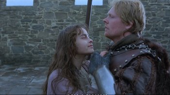 Movie still from “Hamlet” (1990), directed by Franco Zeffirelli – A man and a woman in medieval garb holding a sword; Close Up shot, Over the shoulder angle