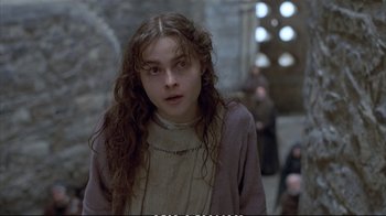 Movie still from “Hamlet” (1990), directed by Franco Zeffirelli – A woman with long brown hair is looking at the camera; Close Up shot, Over the shoulder angle