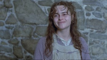 Movie still from “Hamlet” (1990), directed by Franco Zeffirelli – A young woman with long hair smiles for the camera; Close Up shot, High angle