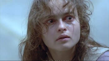 Movie still from “Hamlet” (1990), directed by Franco Zeffirelli – A young woman with long , curly hair stares into the camera; Close Up shot, Low angle