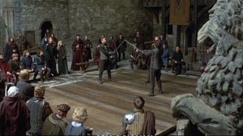 Movie still from “Hamlet” (1990), directed by Franco Zeffirelli – A group of people are playing a game of sword fighting; Wide shot, High angle